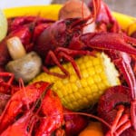 close up of crawfish with corn and mushroom and carrots