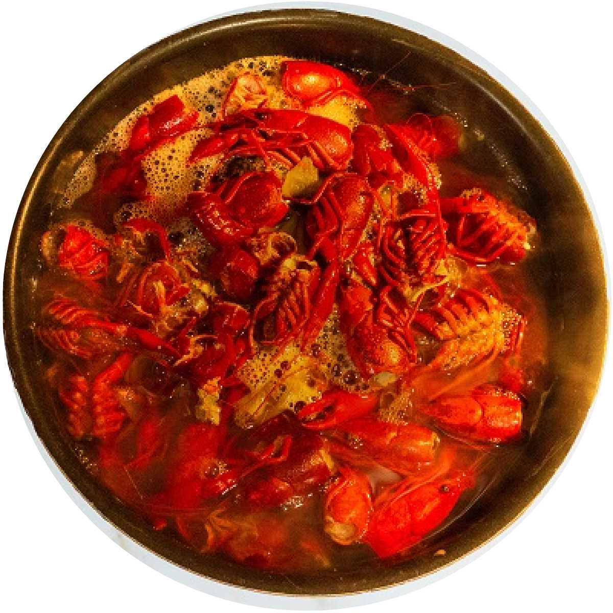 the view from above of a large stock pot boiling crawfish shells