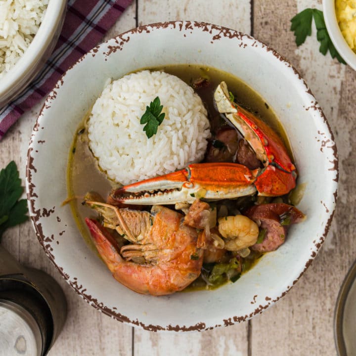 overhead shot of a bowl of seafood gumbo with a scoop of rice