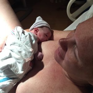 woman holding baby after giving birth