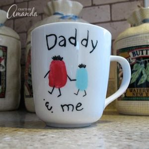 cup with finger prints saying daddy and me