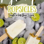 a tray full of key lime pie popsicles on a bed of ice with slices of limes strewn