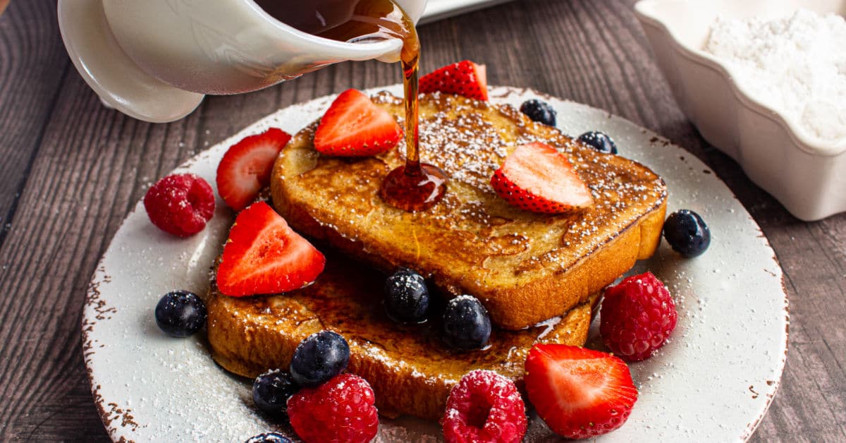 french toast with syrup being poured over