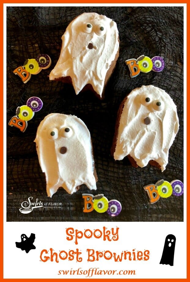 3 Brownies in the shape of ghosts with white icing and edible eye balls