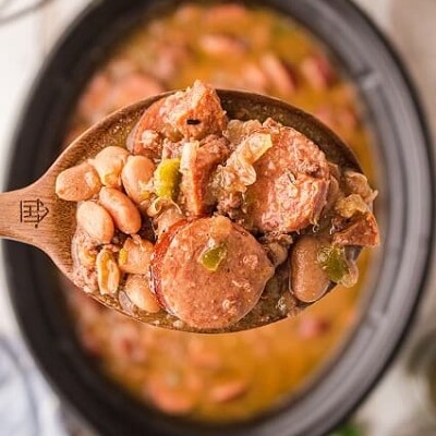 spoon full of pinto beans that have been cooked in a crock pot