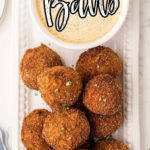 plate of boudin balls with a dip with the title boudin balls on top