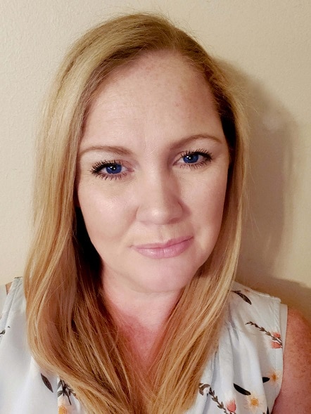 An image showing Melanie Cagle, the founder of The Cagle Diaries. She has long straight strawberry blonde hair and blue eyes.