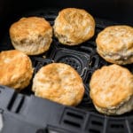 air fryer basket with biscuits inside