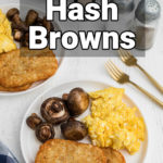 plate in front with hash brown patties and scrambled eggs and mushrooms, with an air fryer in the back