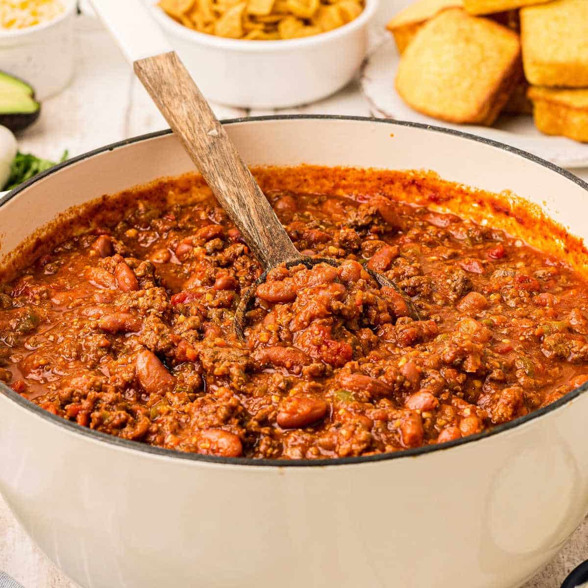 big white pot with deer chili inside with a spoon