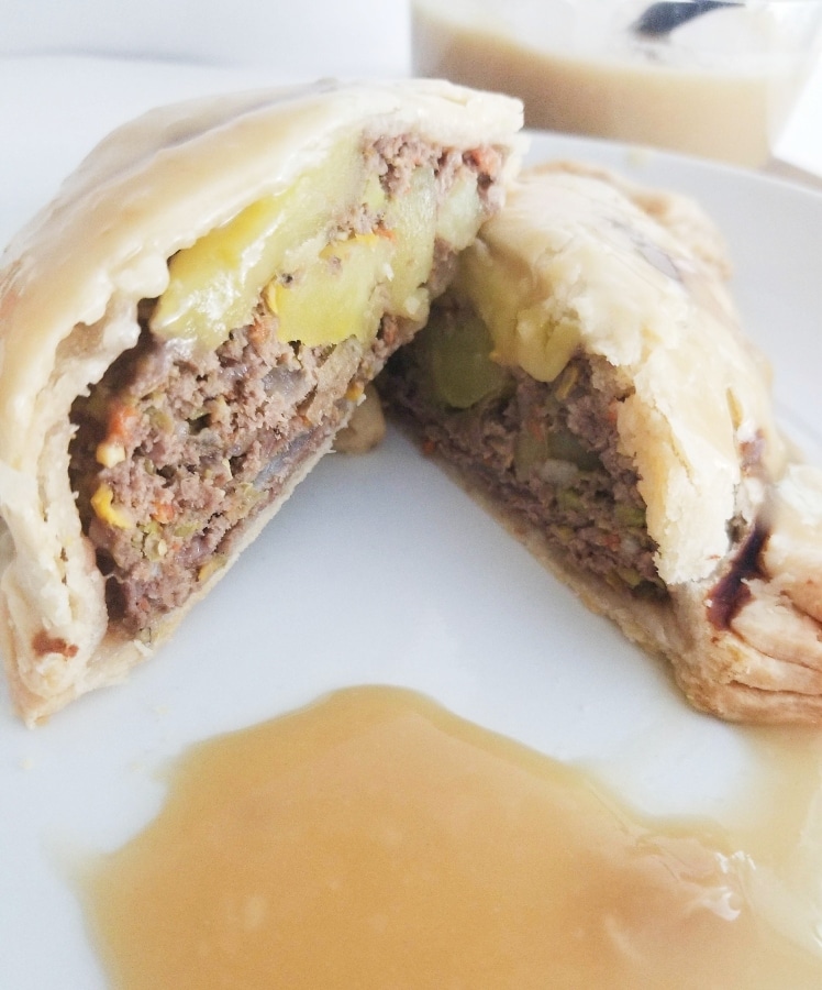 a pastie cut in half, showing the meat and veggies inside