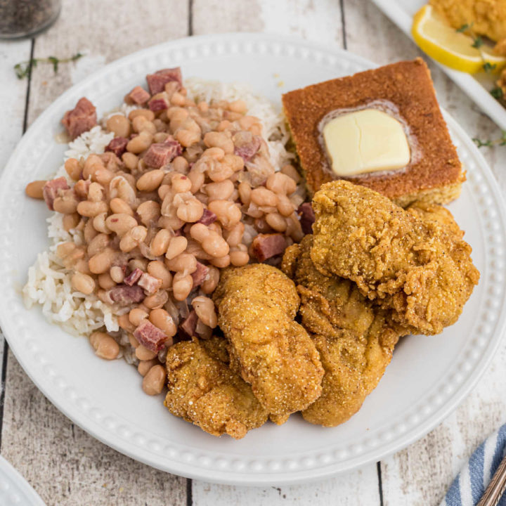 plate of catfish nuggets and white beans with cornbread