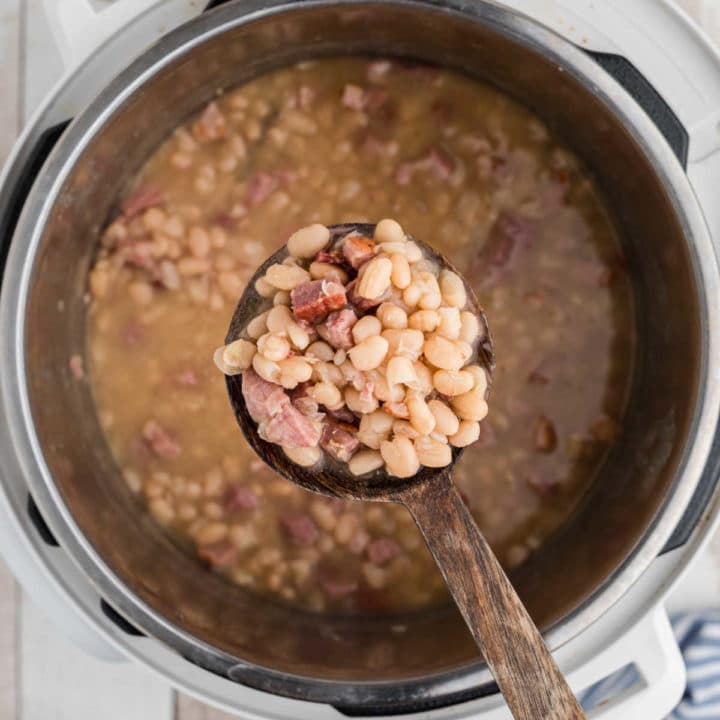 white beans on a spoon over an instant pot