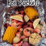 a foil packet full of shrimp, potatoes, garlic, corn and sausage