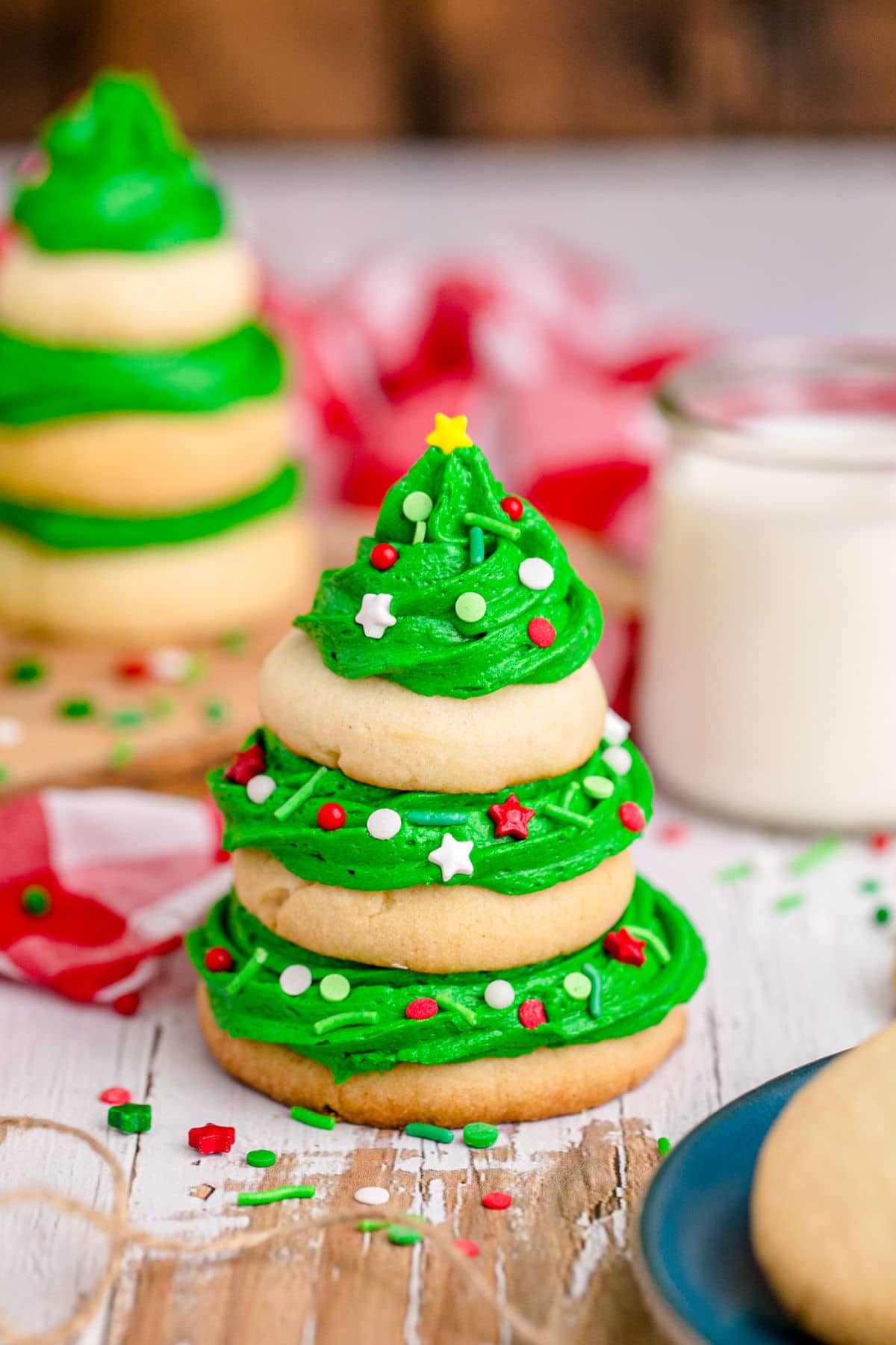 image of a stack of sugar cookies with green frosting that makes it look like a christmas tree