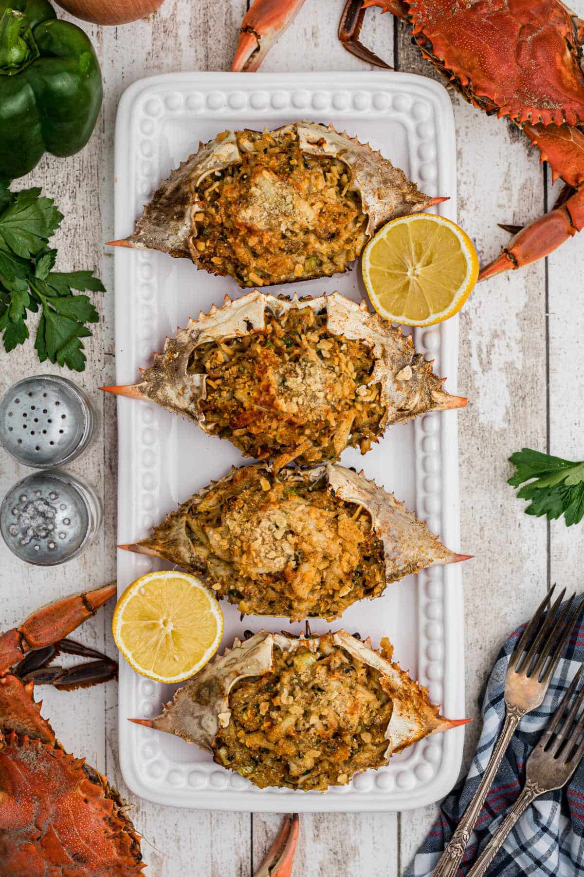 a long plate of stuffed crabs with some boiled crabs on the outside