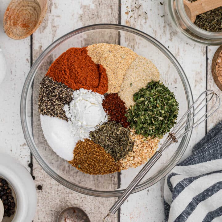 a bowl full of different spices making a creole seasoning blend