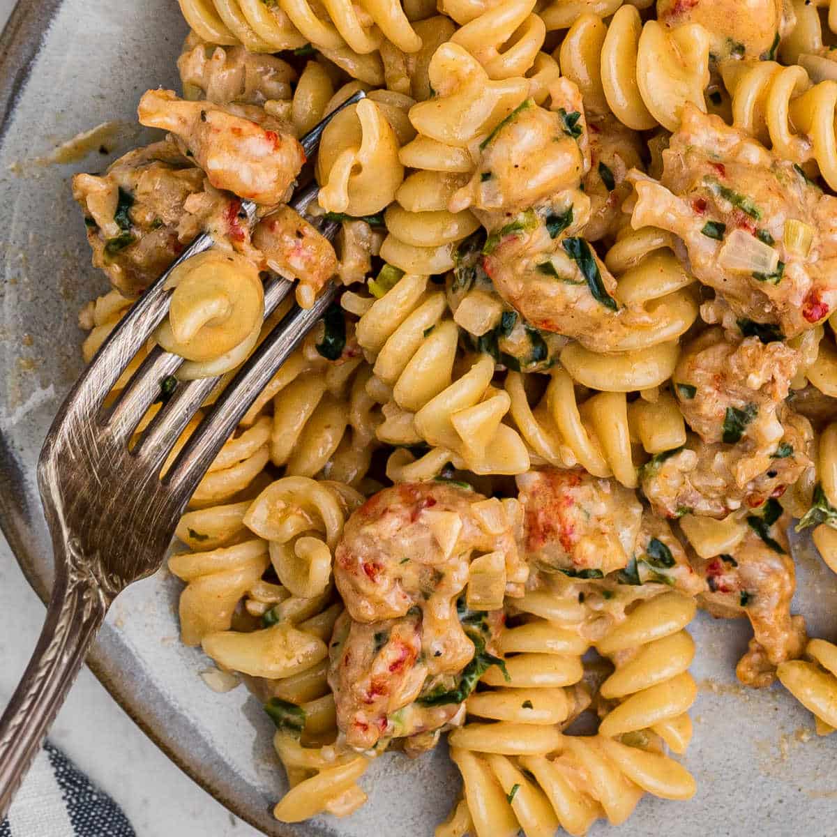 close up of crawfish monica on a plate with a fork digging in