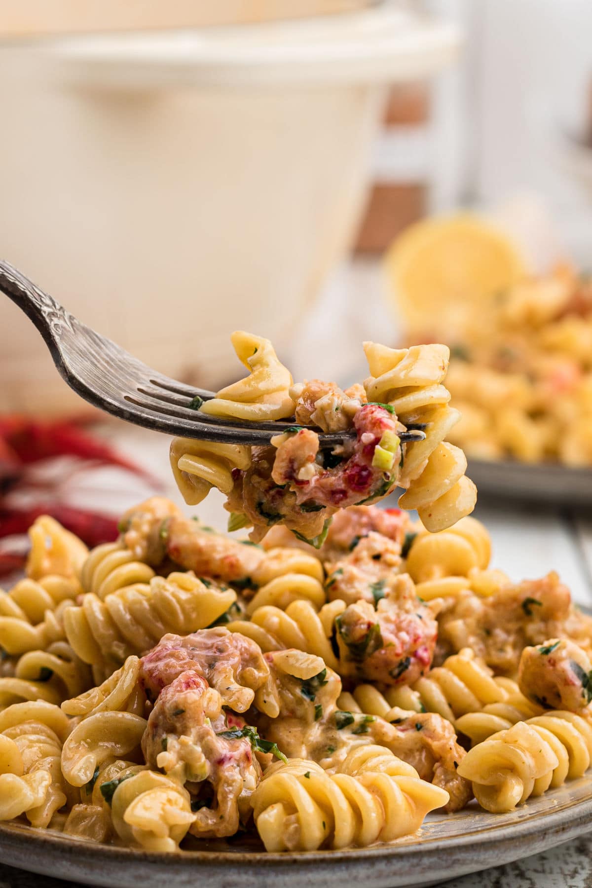 close up of crawfish monica on a plate with a fork digging in