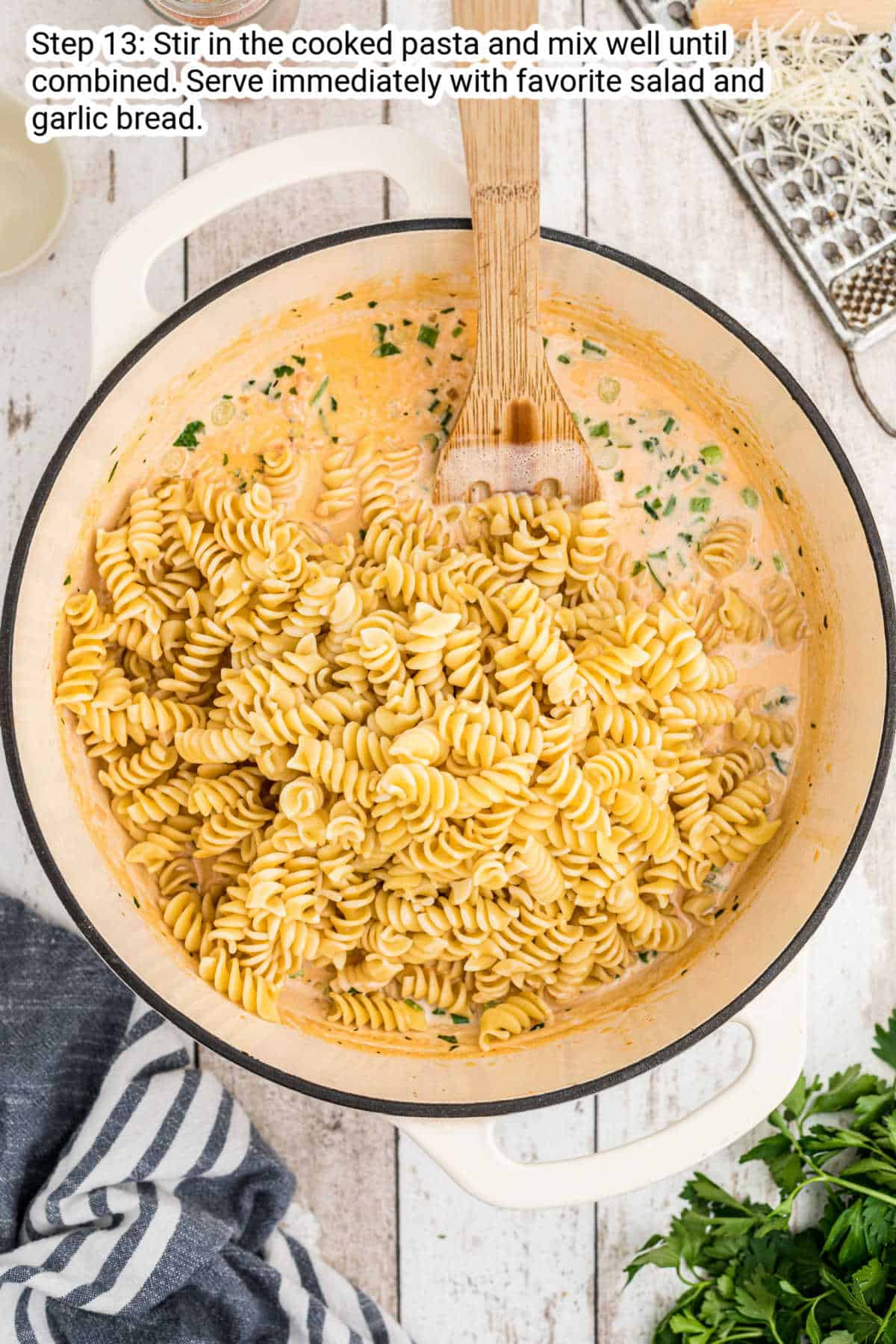 rotini pasta being added to a pot of crawfish cream sauce