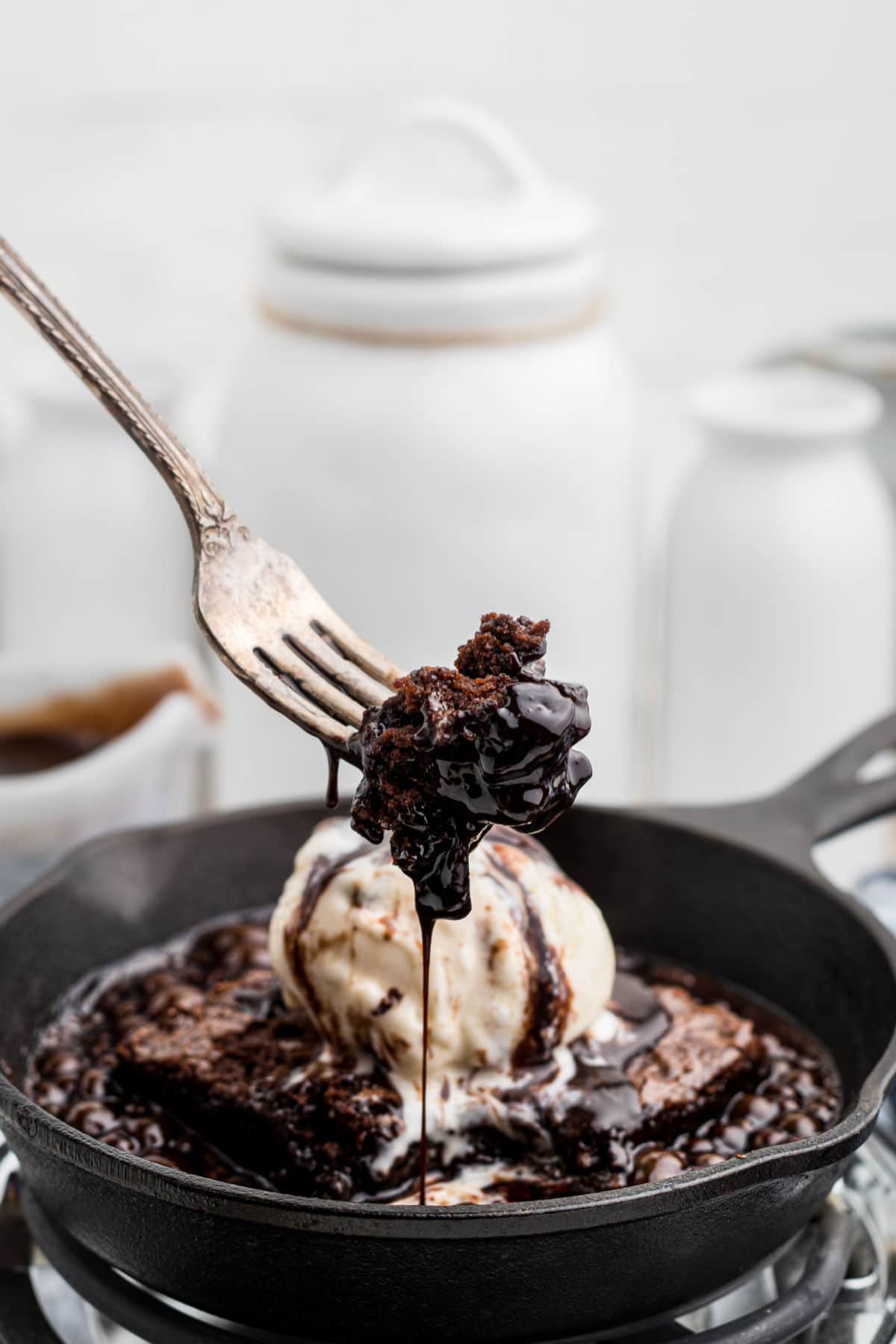 close up of a sizzler brownie with ice cream on top and a fork digging into it