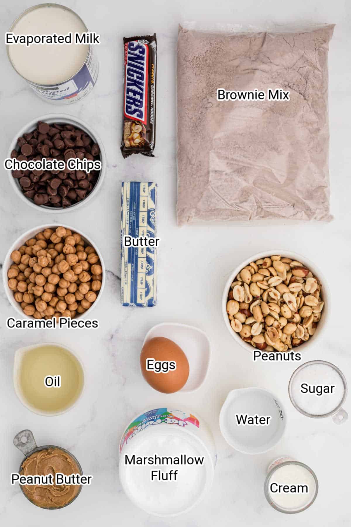 ingredients for snickers brownies all laid out with their names typed over the top