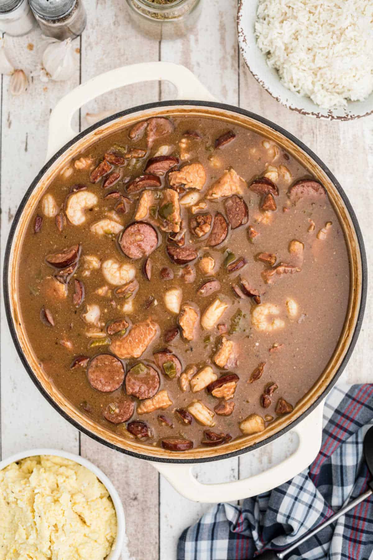 a pot full of alligator gumbo with sausage and shrimp