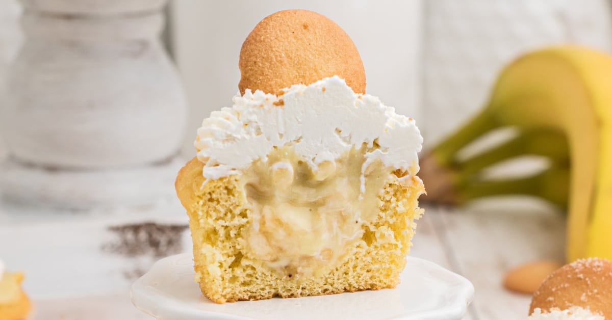 a banana pudding cupcake cut in half to see the center stuffed with banana pudding