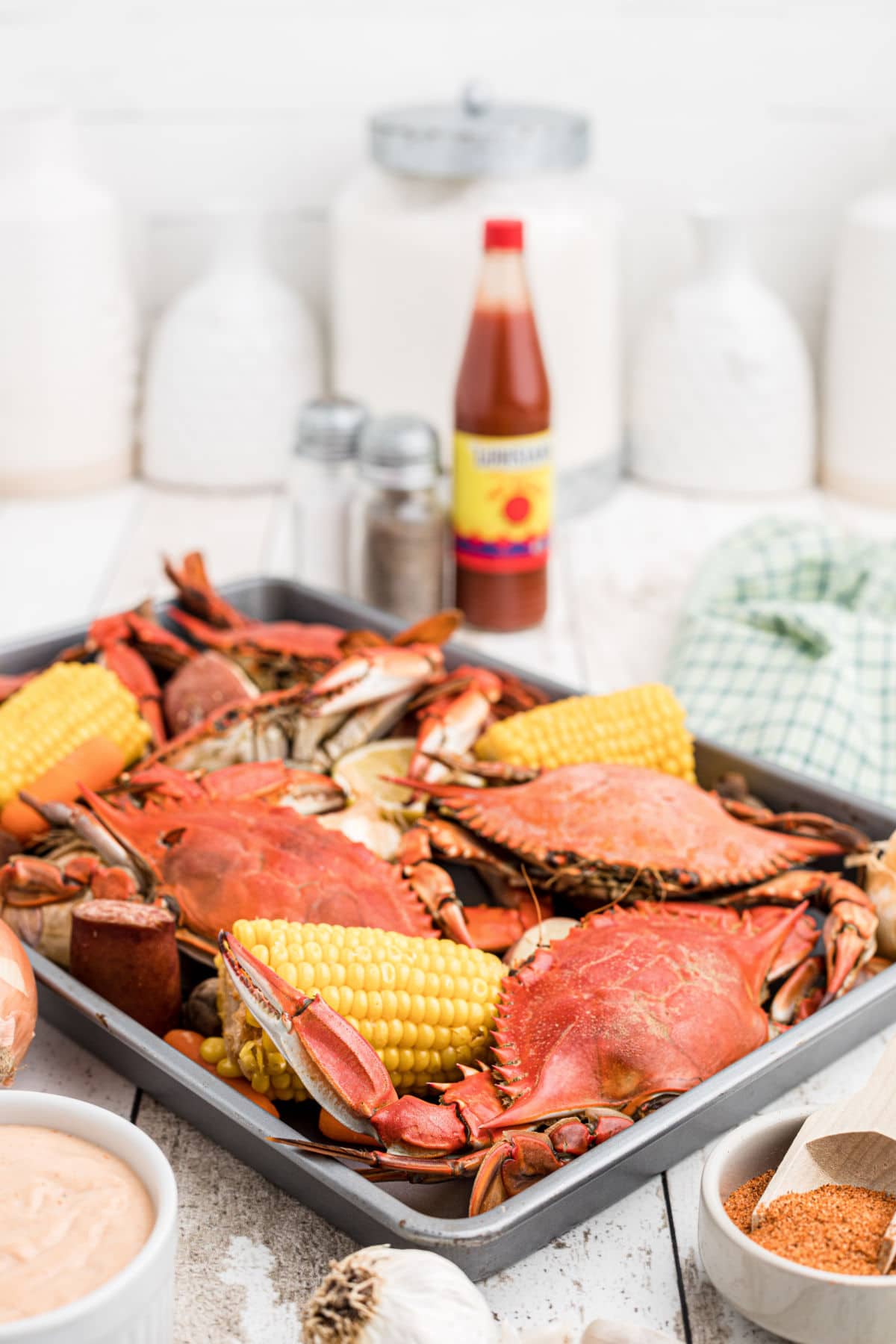 A tray full of Cajun crabs and veggies waiting to be eaten