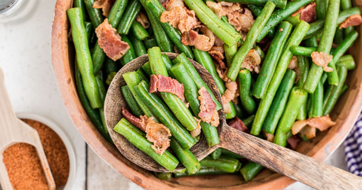 green beans with bacon and a spoon