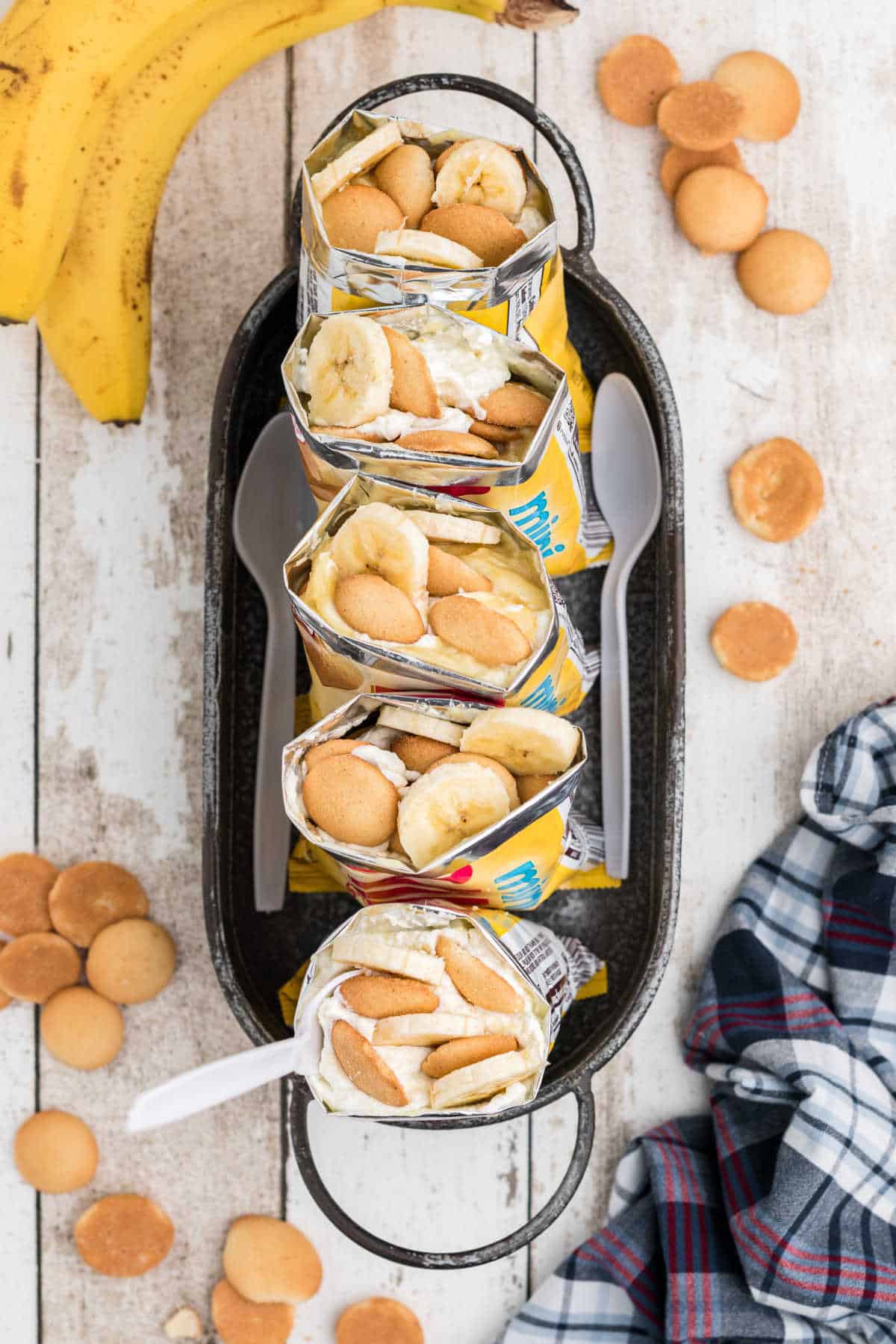 walking banana pudding packets lined up one with a spoon digging in