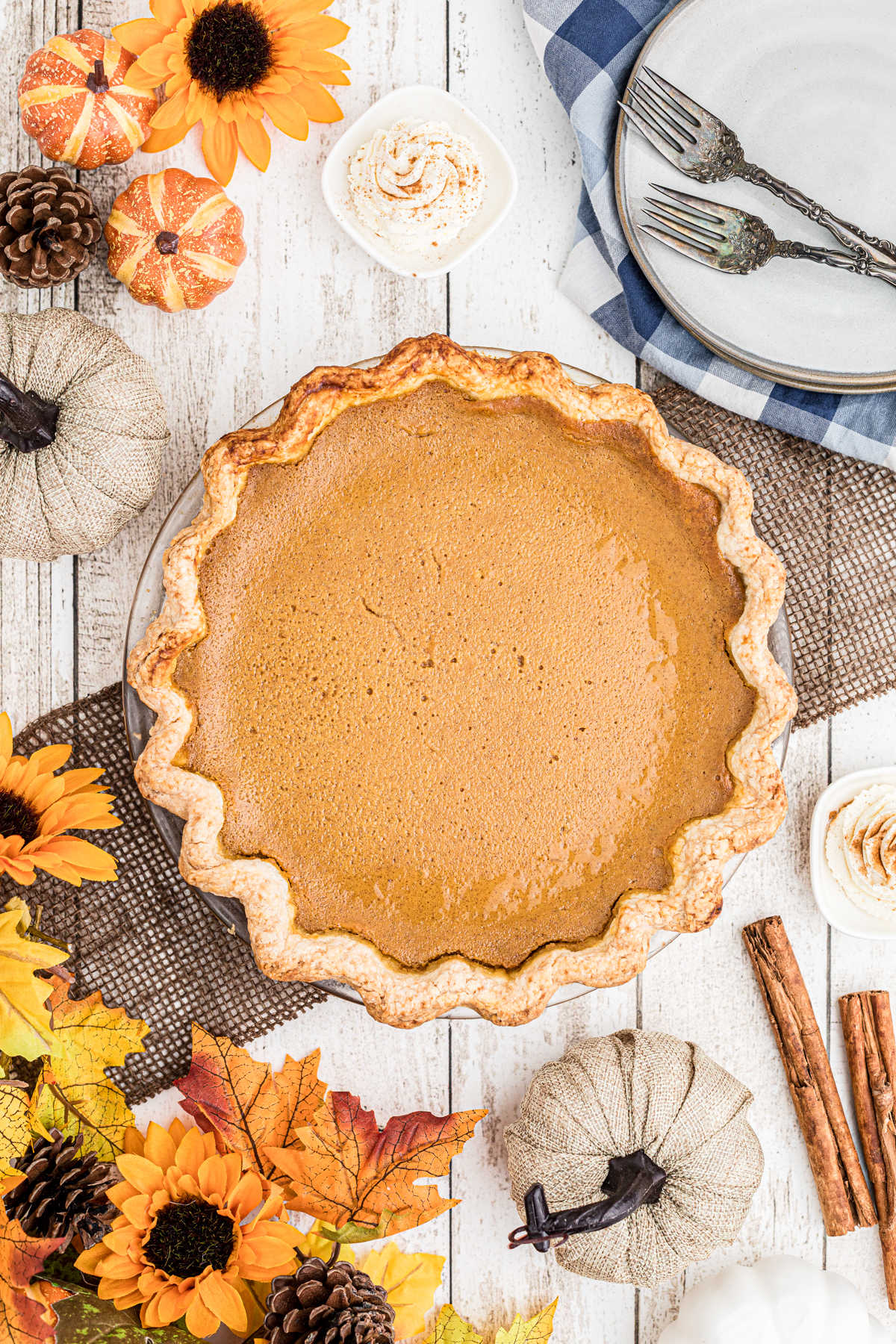 A beautiful Amish pumpkin pie on a table decorated with fall decorations
