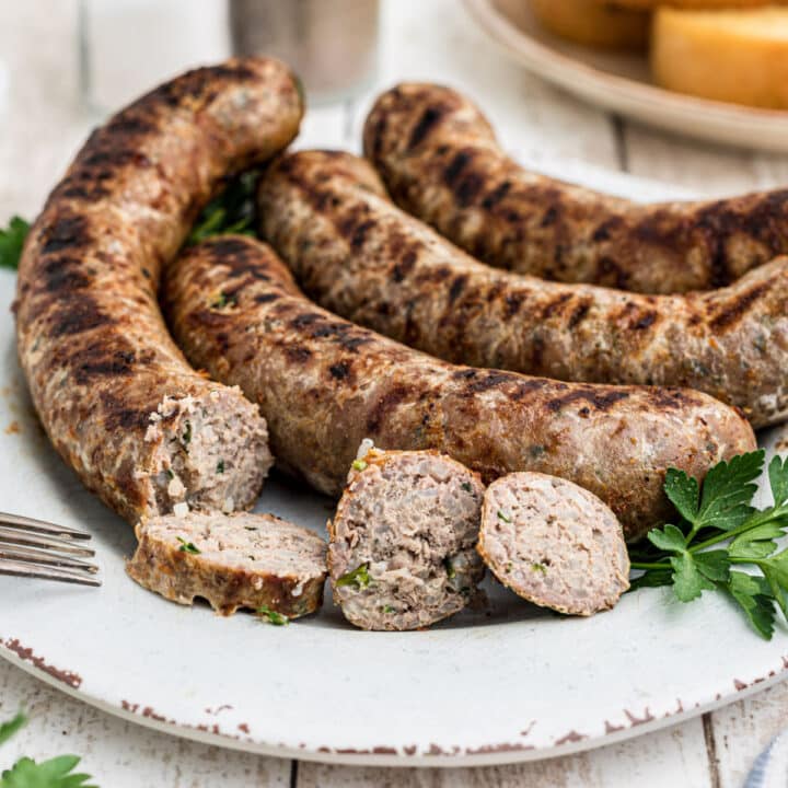 close up of a plate of homemade boudin sausage with a few slices taken from one of the links
