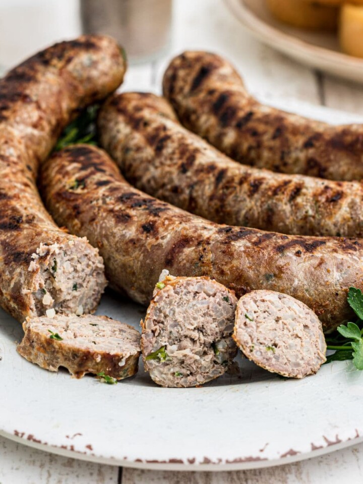 close up of a plate of homemade boudin sausage with a few slices taken from one of the links