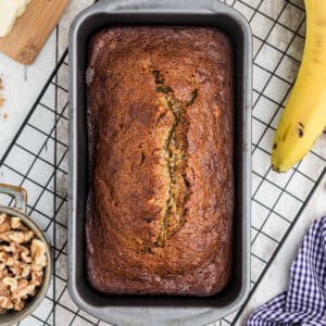 Overhead image of banana bread with mayo in a loaf pan.
