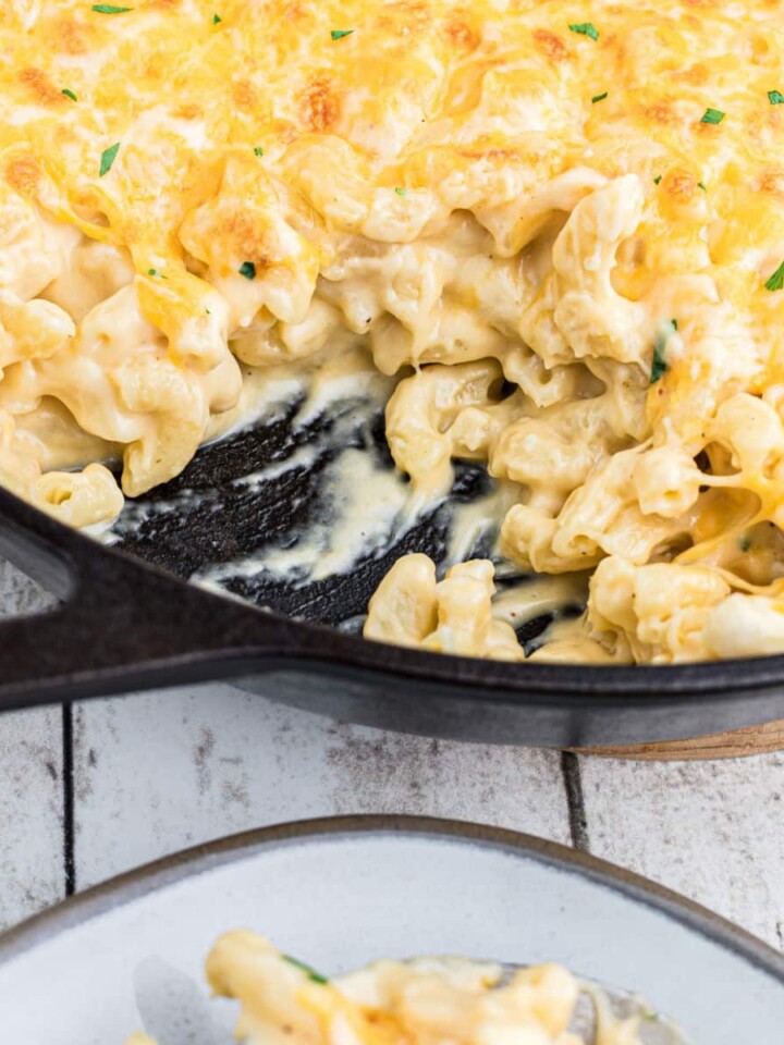 close up of a skillet of mac and cheese with some missing.