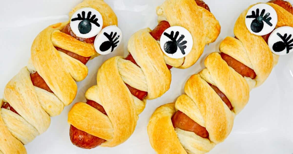 a sausage wrapped with pastry and some eyeballs to look like a mummy