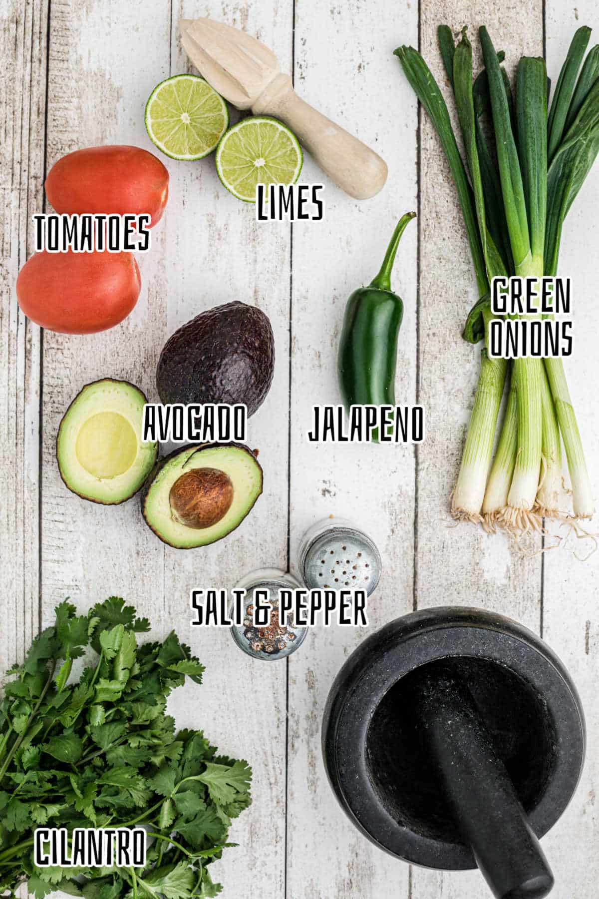 Ingredients needed to make a mortar and pestle guacamole.