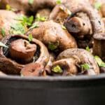close up of some smoked mushrooms in a cast iron pot.
