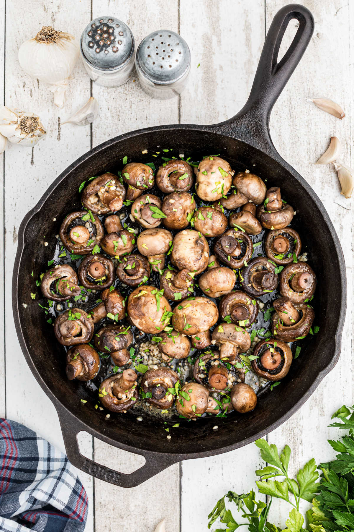overhead shot of smoked mushrooms in a cast iron pot.