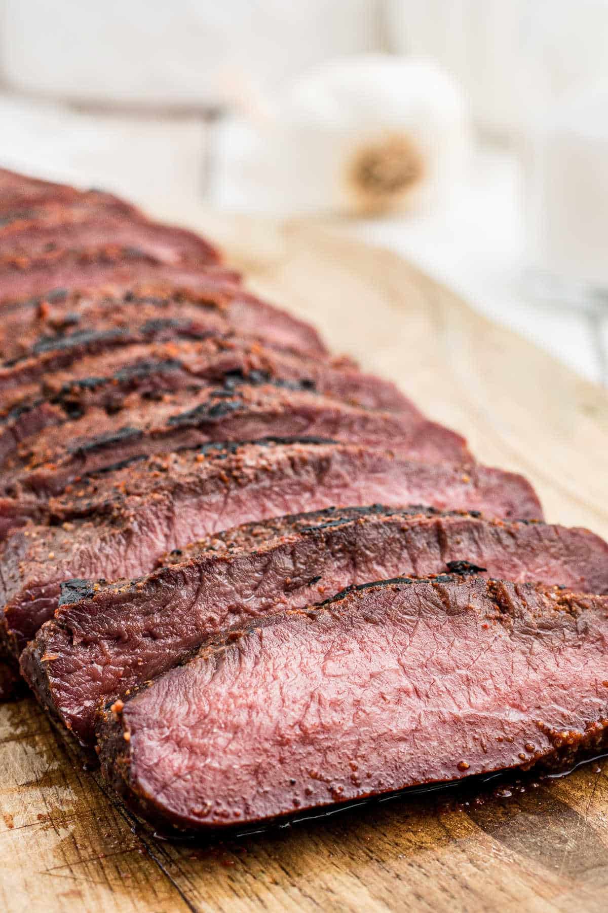 smoked venison backstrap sliced on a board