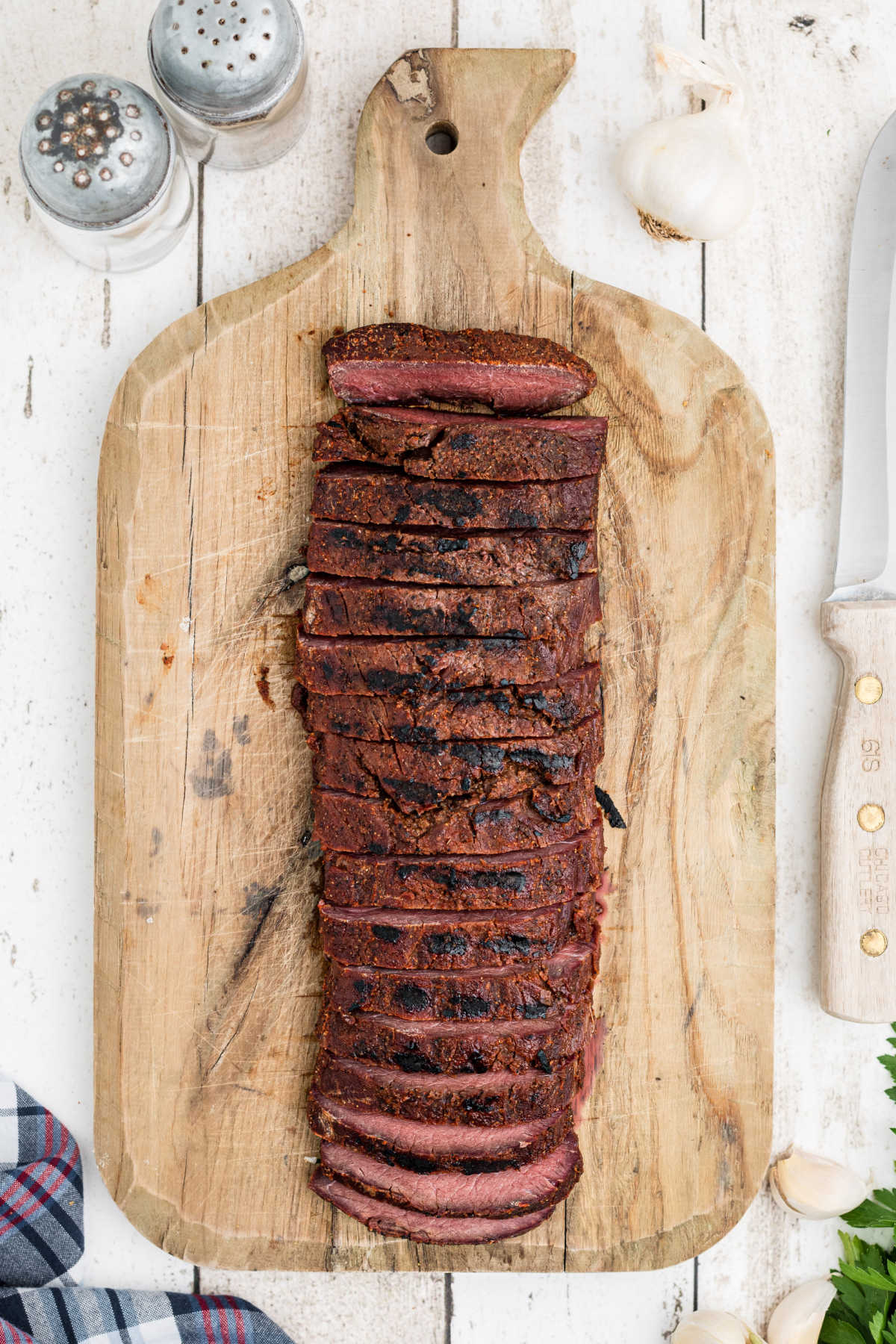 smoked venison backstrap from overhead, sliced on a board