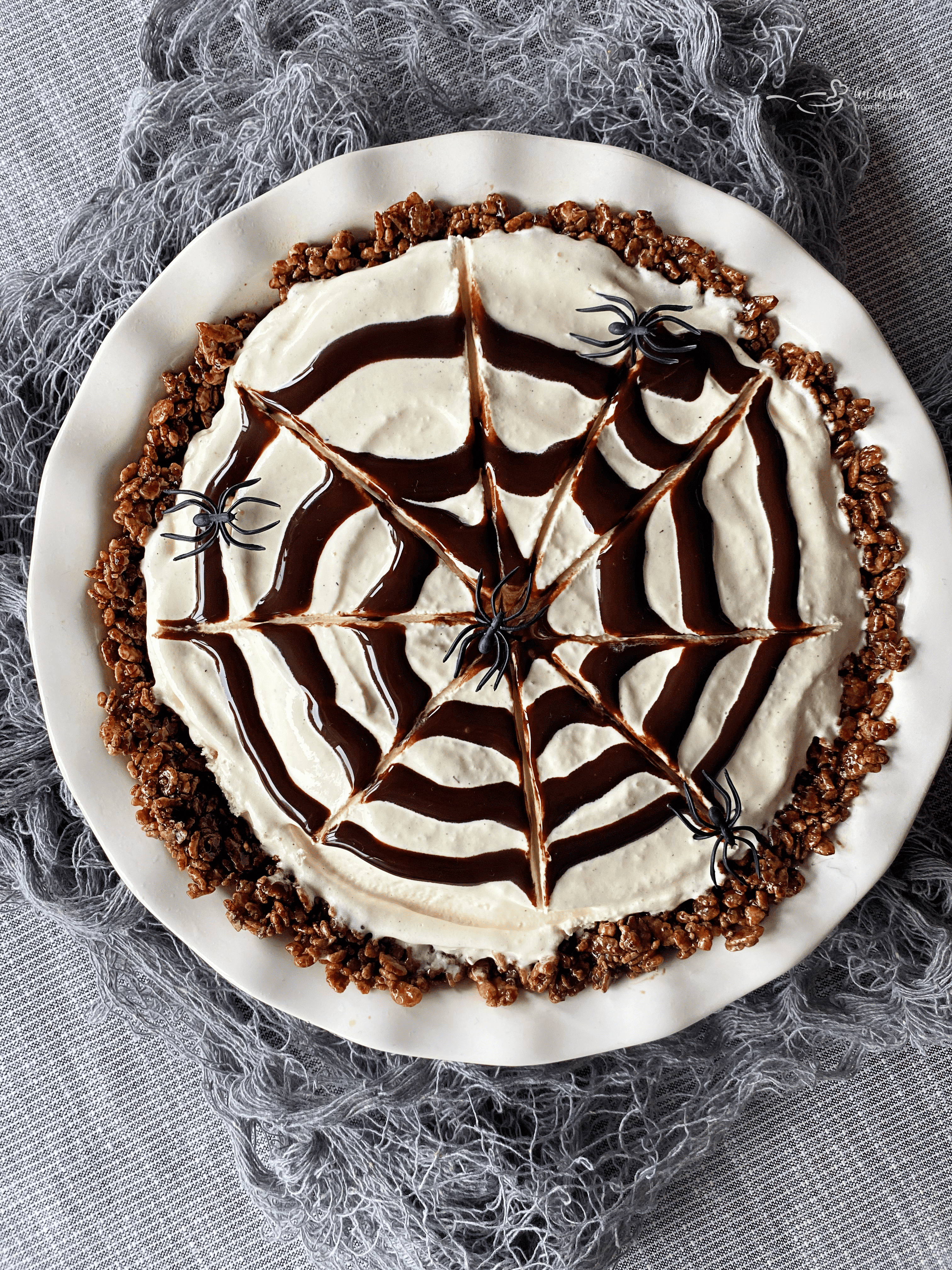 pie with spiderweb decoration on top