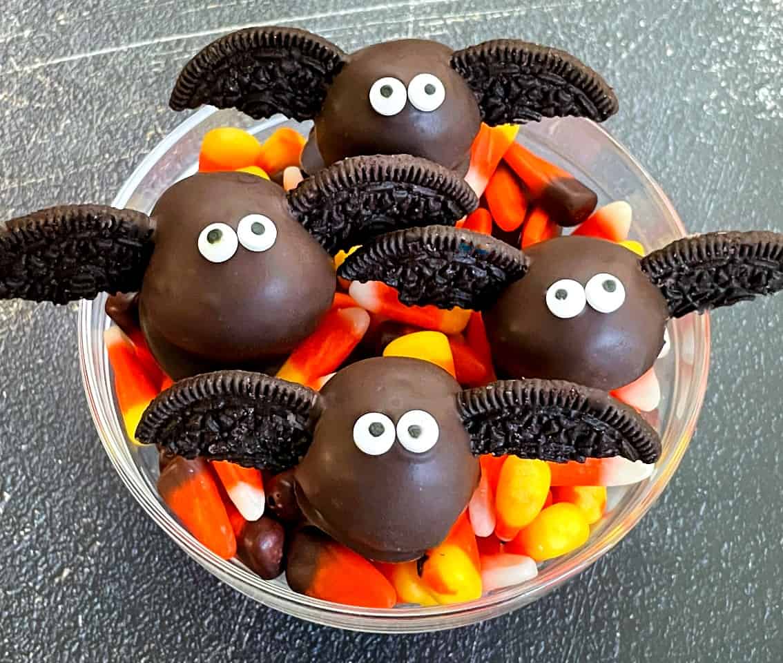 cute bat looking cake pops in a bowl of candy