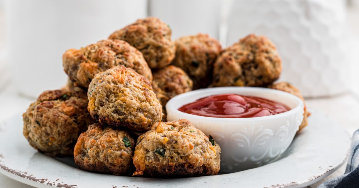 close up of some sausage balls with a ketchup dip.