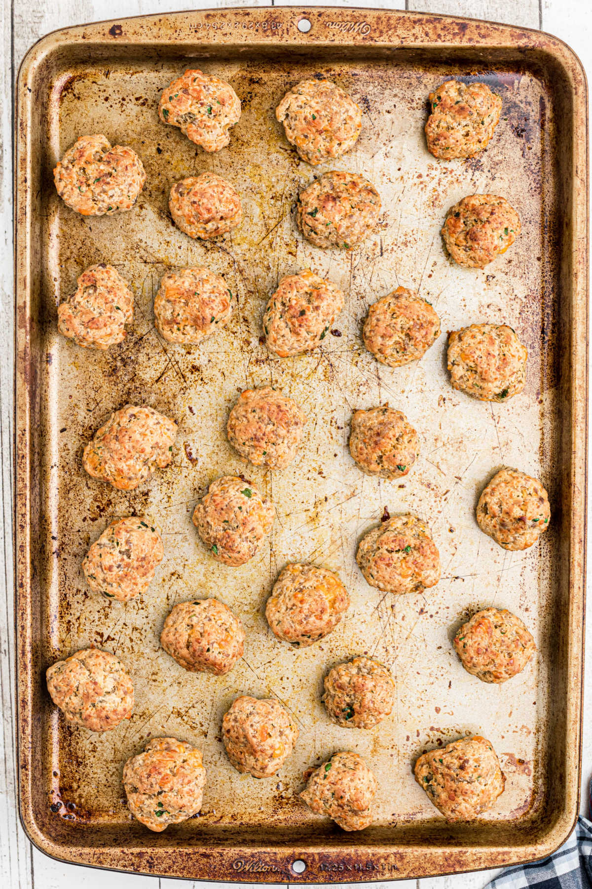 Sausage Balls laid out on a pan after being cooked in the air fryer.