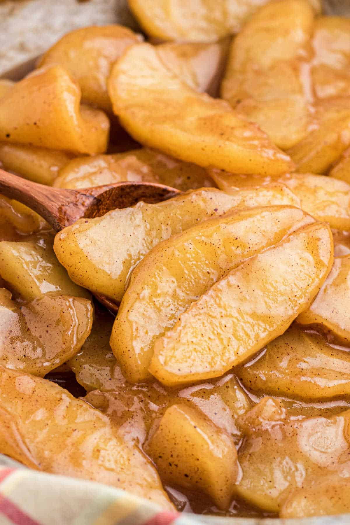 Close up shot of fried apples with a spoon digging in.