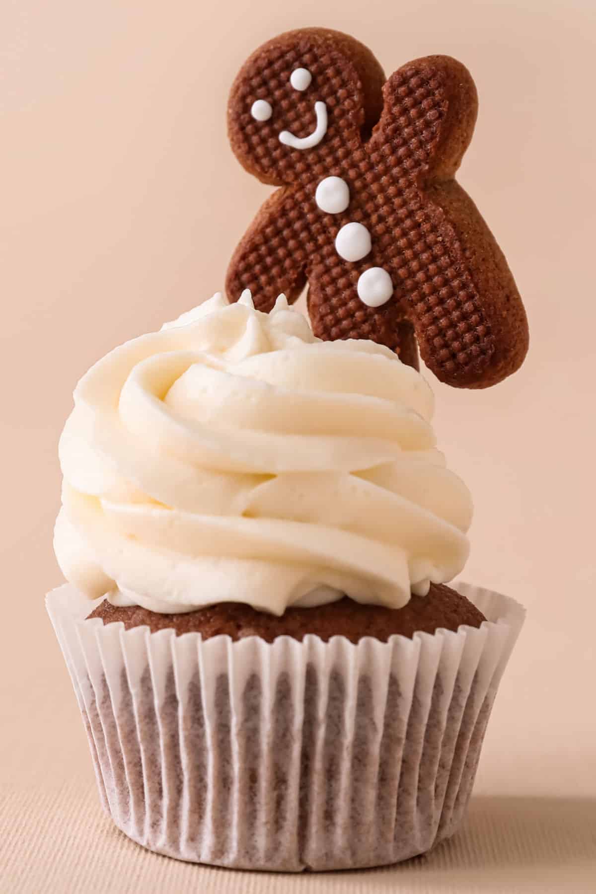 A gingerbread cupcake with a gingerbread man sticking out the top.