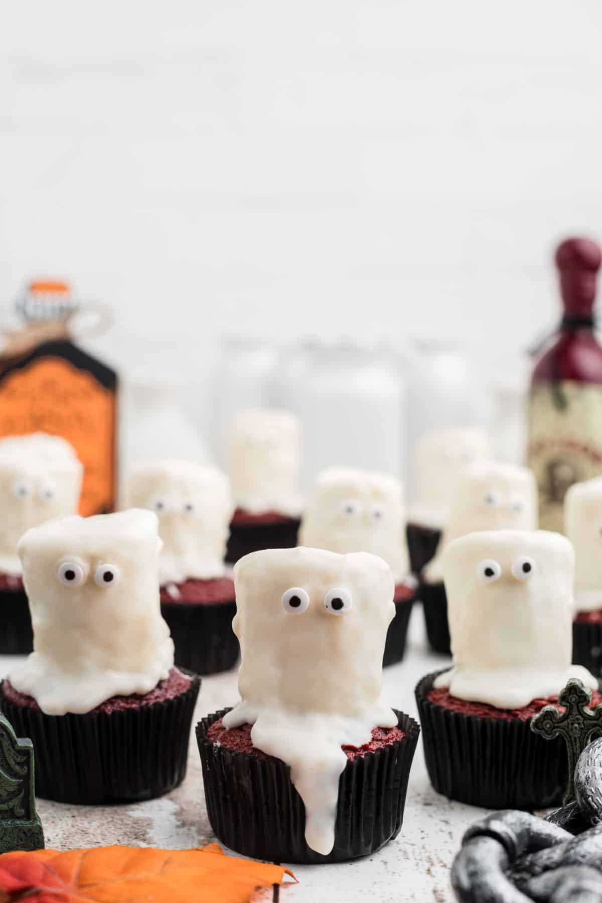 a row of ghost cupcakes decorated for Halloween.