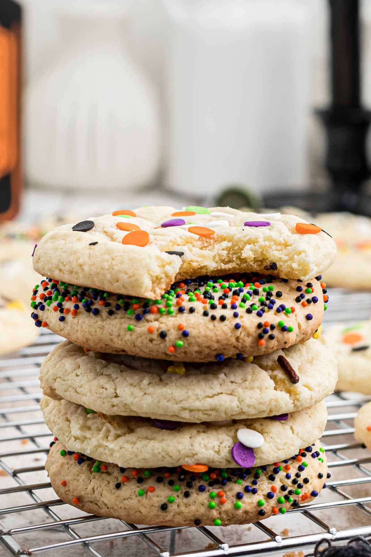 A stack of cookies with halloween colored sprinkles.